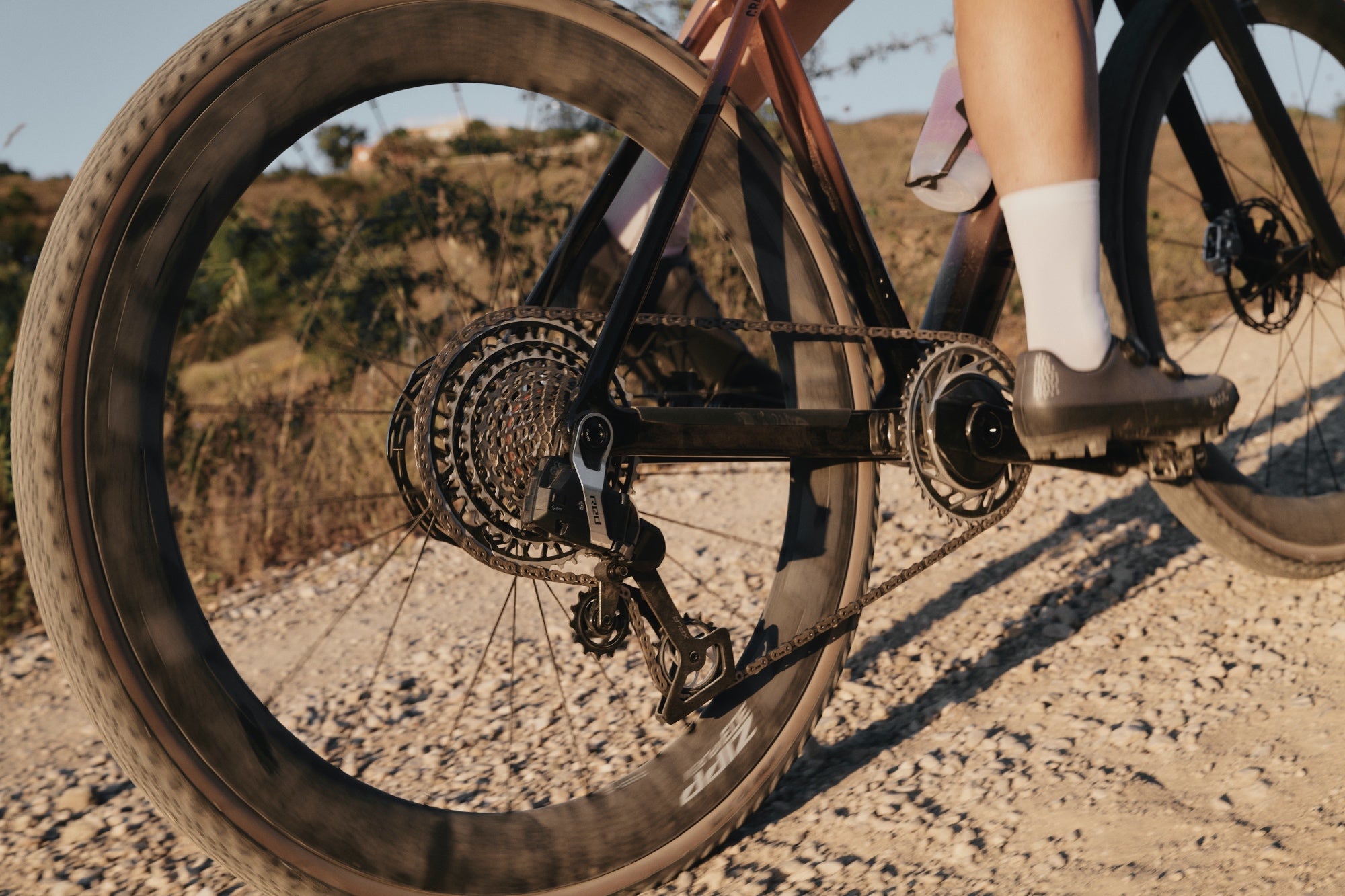 Gravel bike rear wheel showing SRAM Red XPLR AXS drivetrain