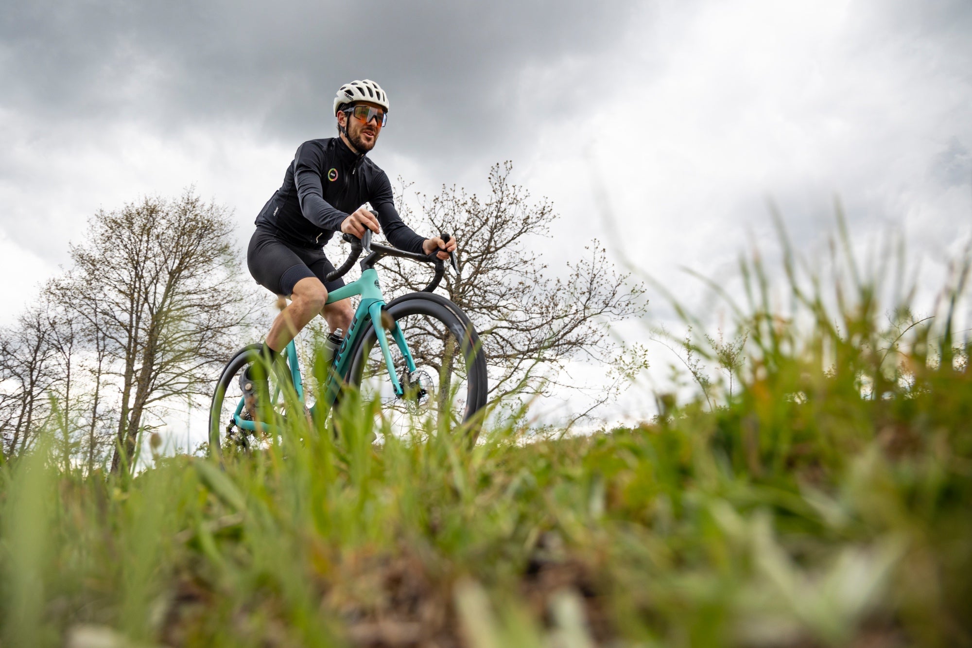 A man on a Bianchi with a Mahle X30 drive unit on a hill